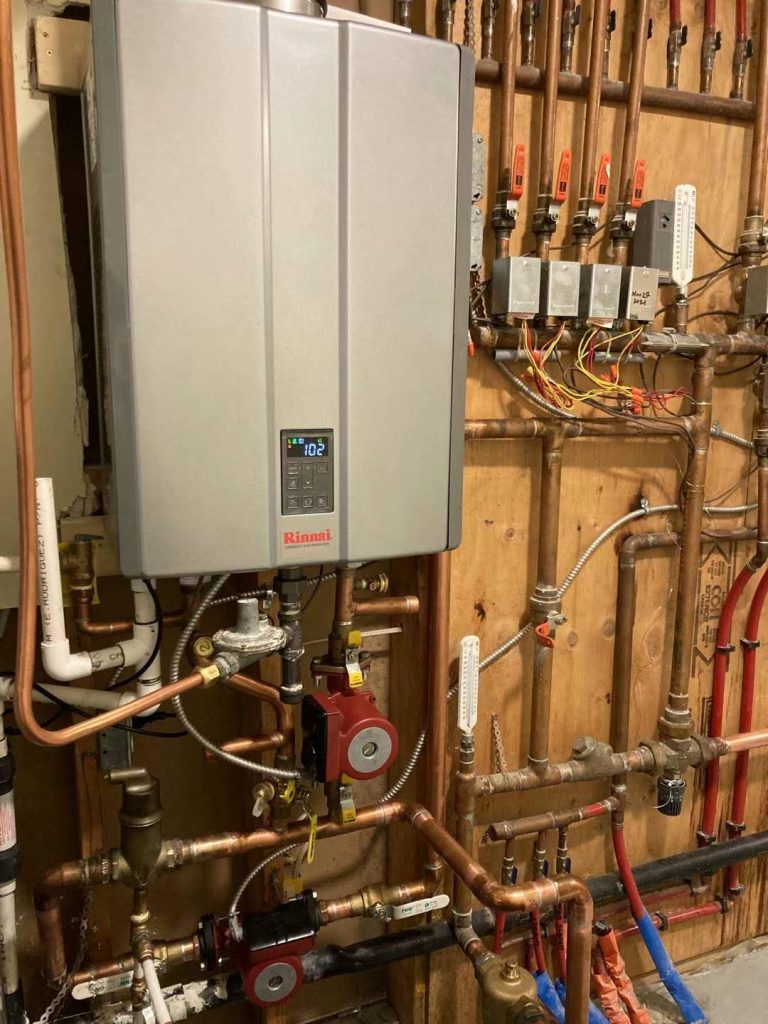 Rinnai tankless water heater installed with copper piping in Coquitlam, BC. Energy-efficient HVAC setup by Alliance Total Solutions.